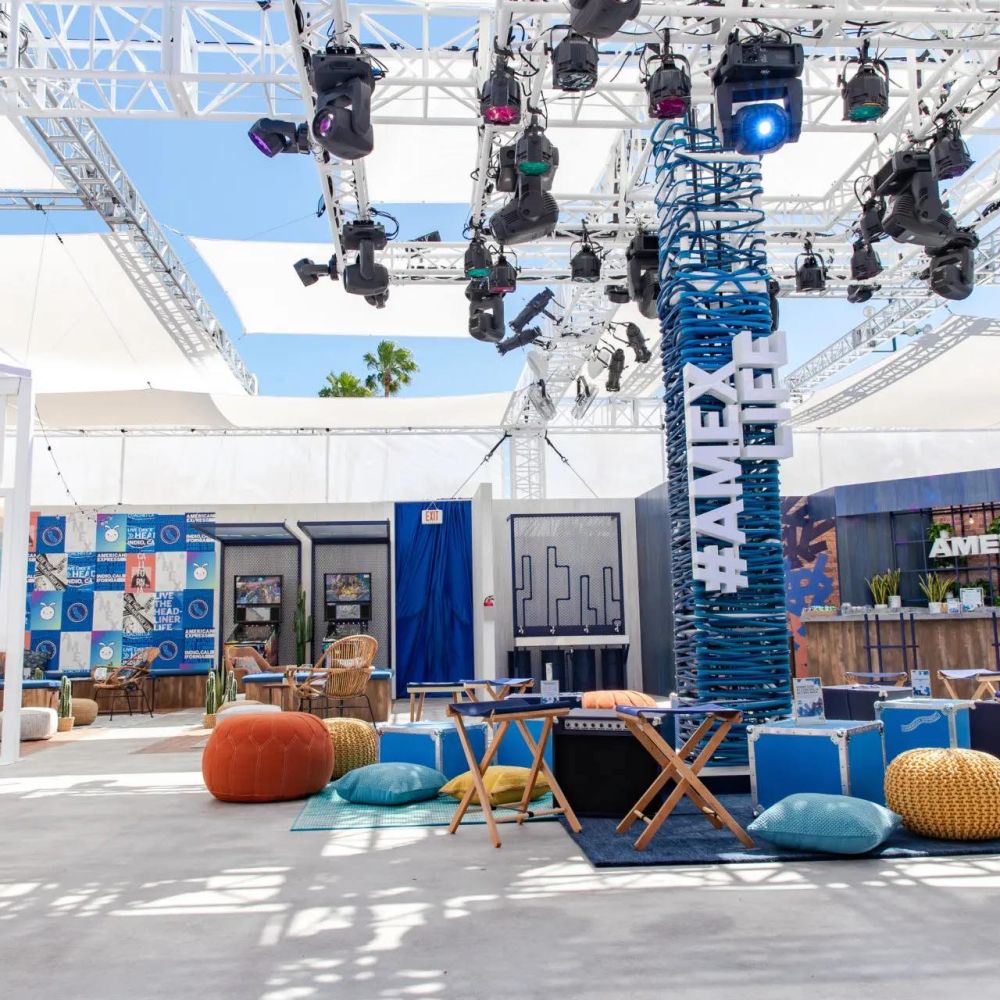 American express lounge at Coachella with bean bags and a lighting rig.
